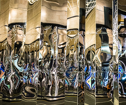 A wall of mirrors showing distorted reflections