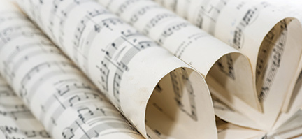 Pages of music notation curled over